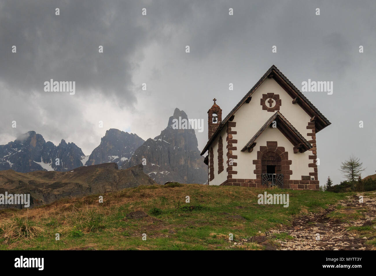 Chapel at Rolle Pass, one of the oldest roads in the Dolomites. The road connects the valleys of Fiemme and Primiero Stock Photo