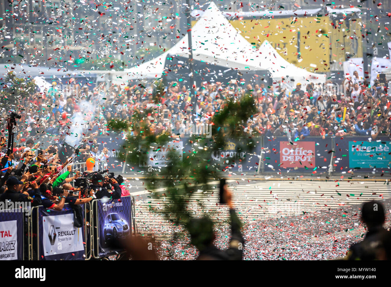 Mexico City, Mexico - June 27, 2015: Audience gone crazy watching the F1 Cars burning wheels and flying confetti, at the Infiniti Red Bull Racing F1 Showrun. Stock Photo