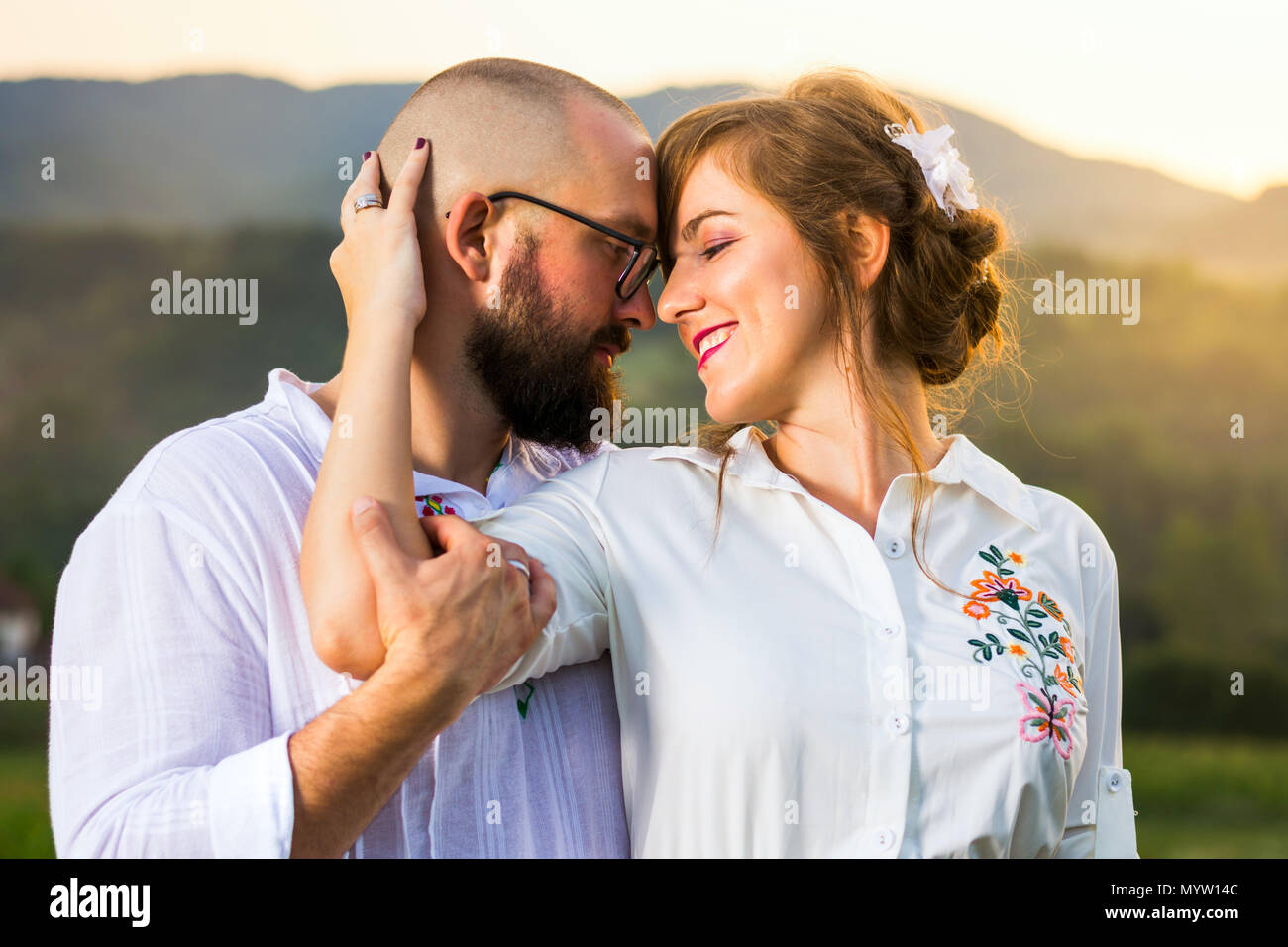 Passionate couple looking each other before kiss at sunset Stock Photo