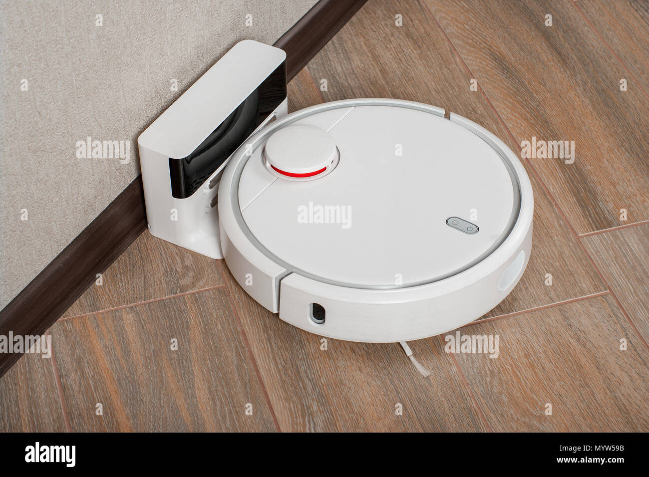 Robot vacuum cleaner on charging dock after it is finished. Modern