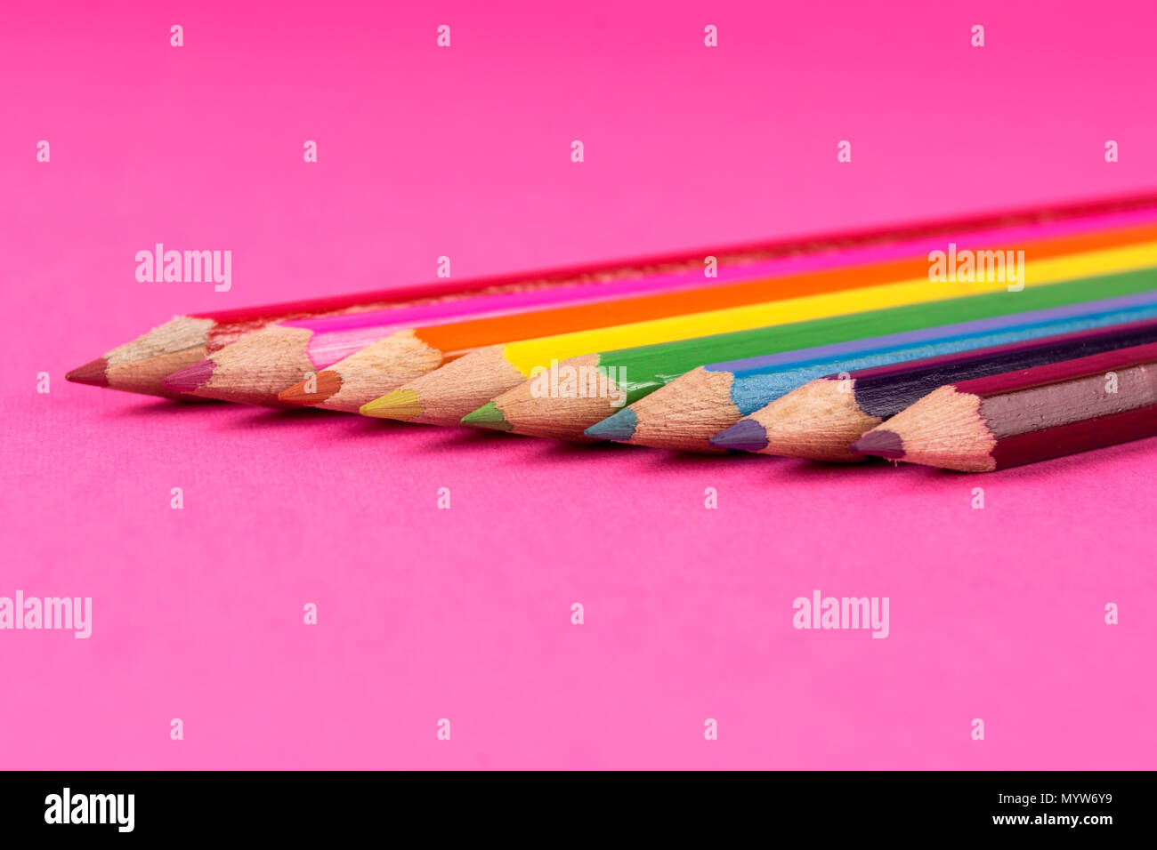 Colored wooden pencils on pink background and space. Art and education concept. Close up, selective focus Stock Photo