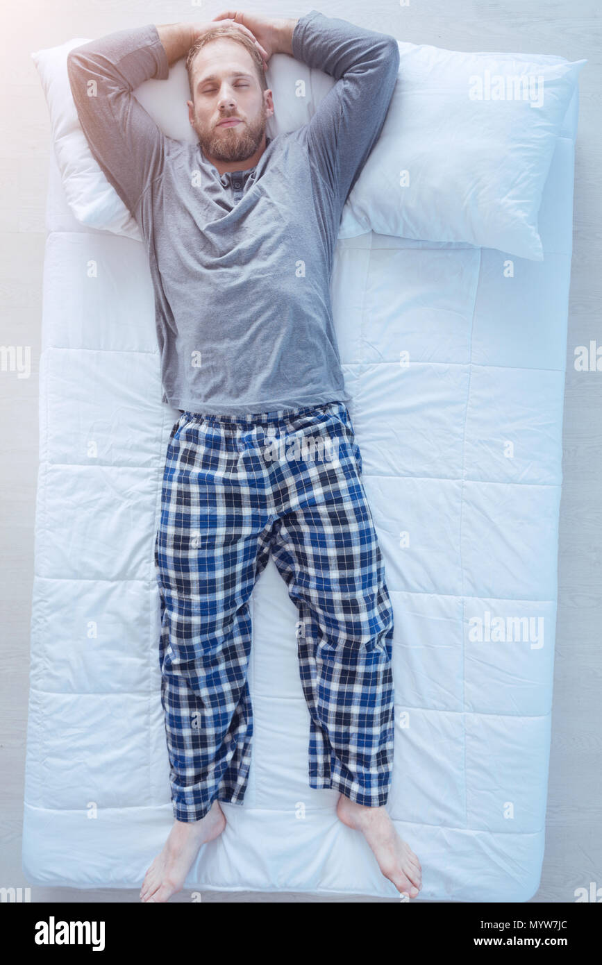 Bearded guy sleeping tight in bed Stock Photo Alamy