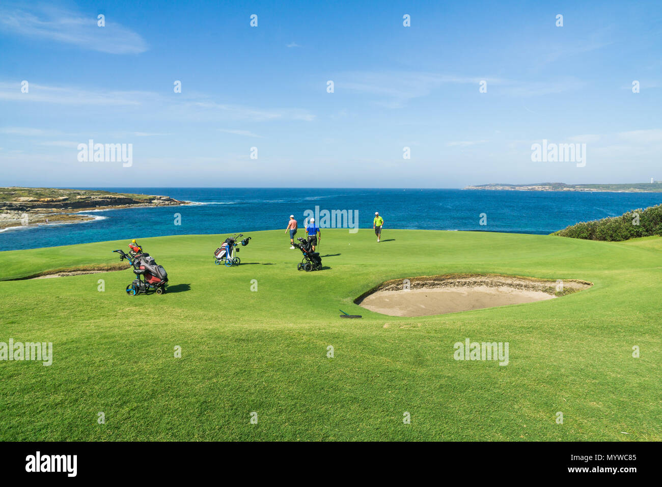 Some players on one of the scenic greens at the New South Wales Golf Club in Botany Bay, Sydney Stock Photo