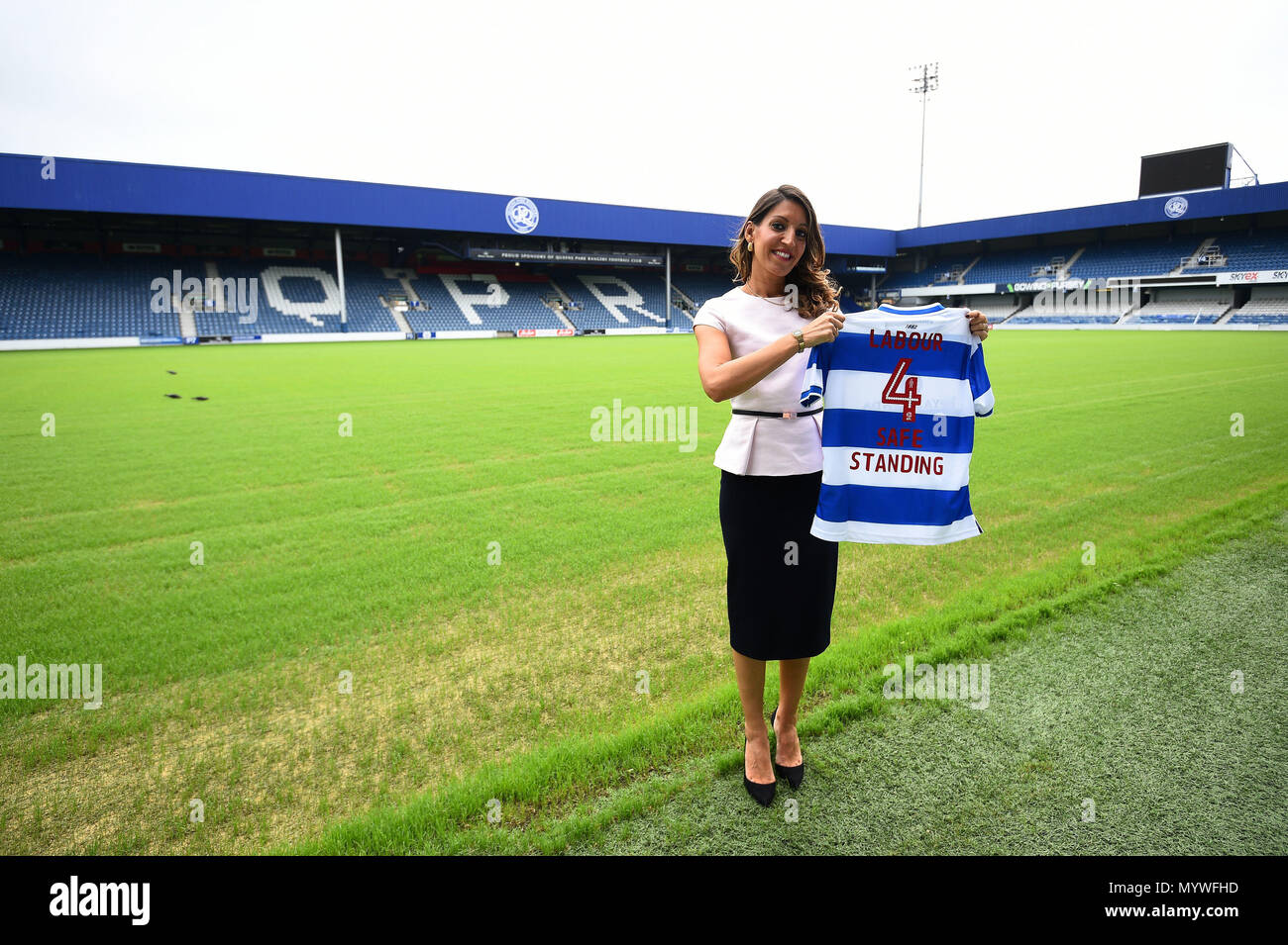 Shadow sports minister Rosena Allin-Kha holds a Labour 4 Safe Standing t-shirt, at Loftus Road, Queens Park Rangers ground, in West London as Labour has come out in favour of safe-standing in the Premier League and Championship, increasing the pressure on the government to follow suit. Stock Photo