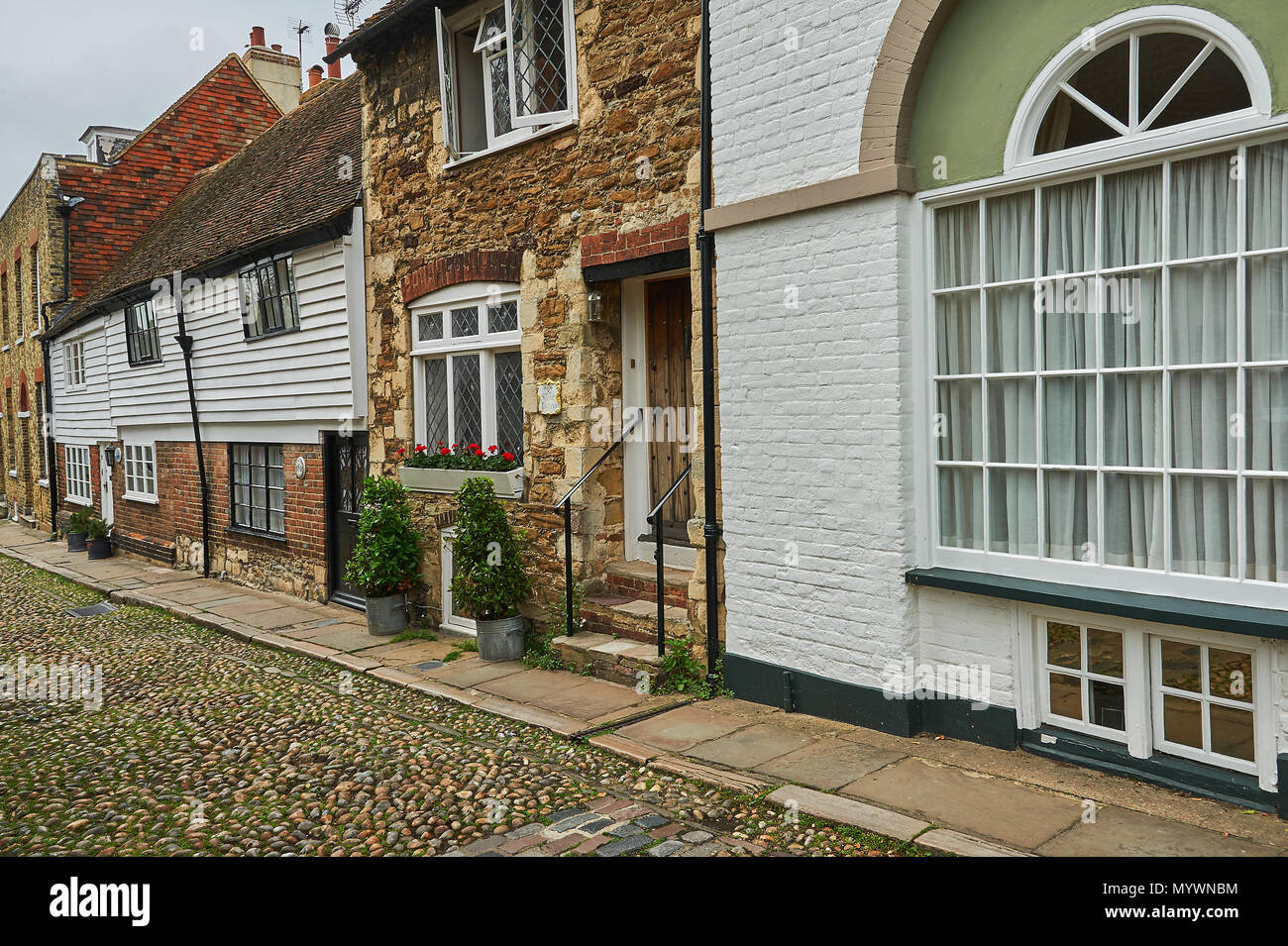 A mix of building style line the cobbled streets in the centre of Rye, Easr Sussex Stock Photo