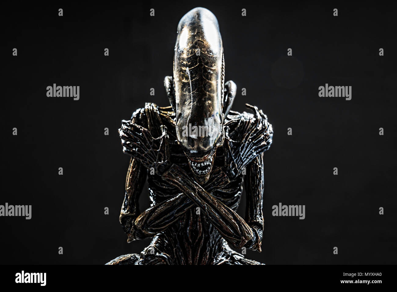 Alien figure from “Alien Covenant” picture, In Crossing Arms position. This is the Alien xenomorph version from 2017 Alien Covenant movie. Made by NEC Stock Photo