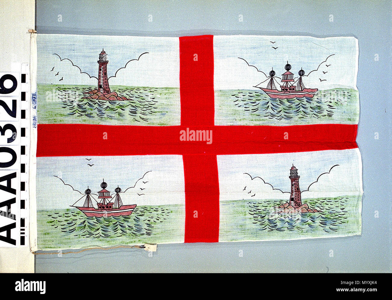 .  English: Flag, Irish Lights Commissioners The flag of the Irish Lights Commissioners. It is made in synthetic fibre bunting and is machine-sewn. The design consists of a red St George's cross on a white background with a painted lighthouse and lightship in alternate cantons. Marked in ink on the hoist: 'IRISH LIGHTS'. The flag has a rope and toggle attached. The new version of this flag, introduced in September 1970, has the cross of St Patrick instead of that of St George. The Irish Lights Commissioners is the lighthouse authority for all the island of Ireland, its adjacent seas and island Stock Photo