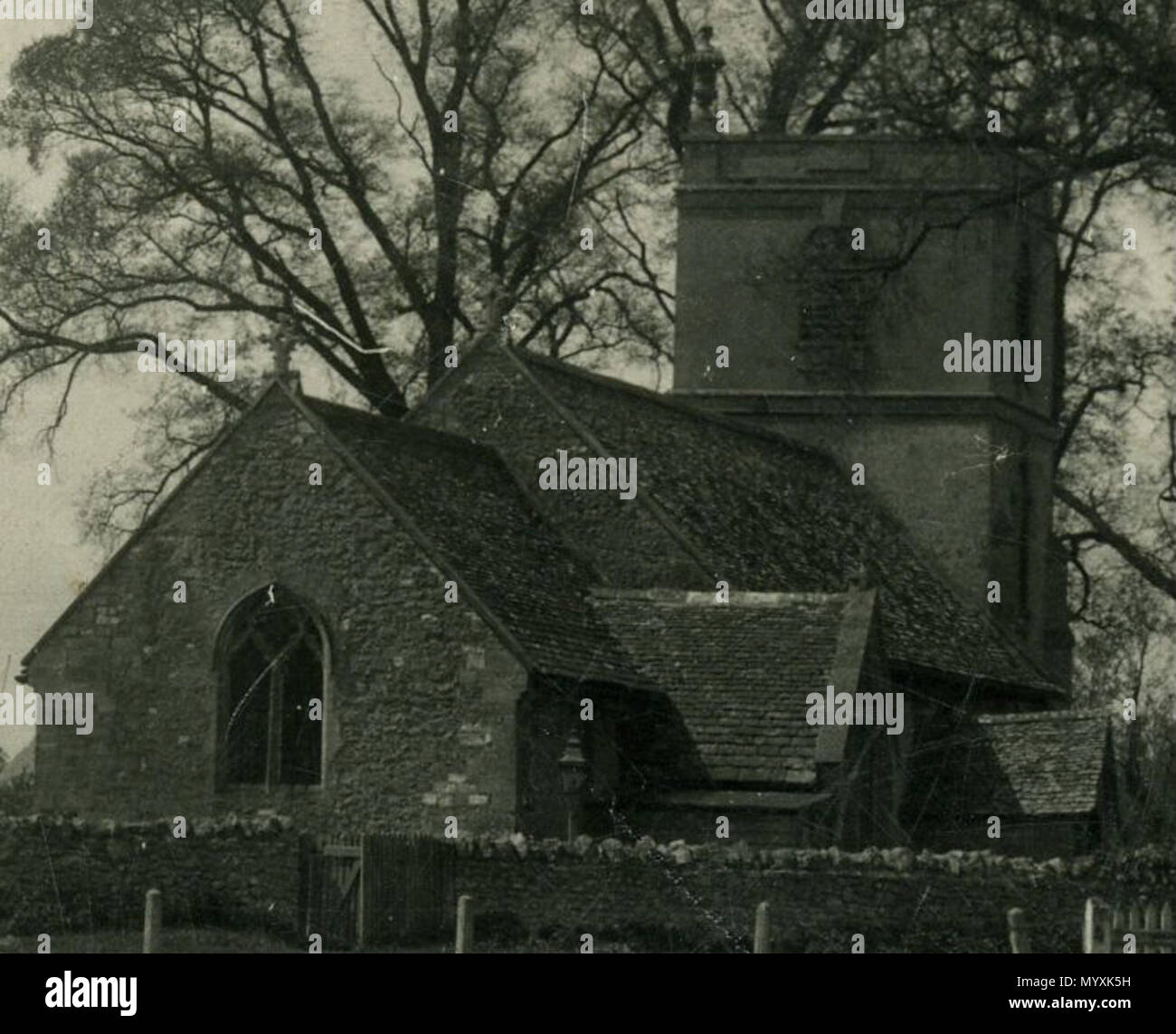 . English: Closeup of part of postcard of Longcot, Valeof White Horse, England, showing the parish church. The stone urns on the tower were removed in the 1970s for safety. The photographer was Fred C. Palmer of Tower Studio, Herne Bay, Kent ca. 1905-20, and of 6 Cromwell Street, Swindon ca. 1920-36. He is believed to have died 1936-39. The postcard is postmarked 1935, so the photo may have been taken close to the end of his career. This print has darkened with age, but it would be inappropriate to adjust the brightness because detail, e.g. clouds in the sky, would be lost.  . Postmarked 1935. Stock Photo