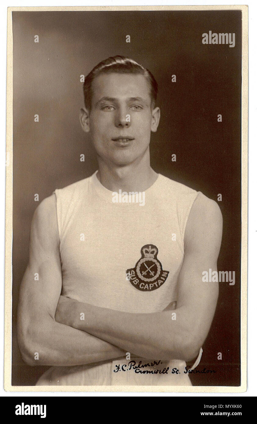 . Portrait photo of a young sportsman at Swindon, Wiltshire, England in the 1920s or 30s. The badge represents the Army Physical Training Corps. The sub-captain rank possibly indicates that he is a footballer. From a postcard deposited at Swindon Record Office and scanned and uploaded by them to Flickr. The photographer was Fred C. Palmer of Tower Studio, Herne Bay, Kent ca.1905-1920, and of 6 Cromwell Street, Swindon ca.1920-1936. He is believed to have died 1936-1939. Points of interest  The glossy hair-oil, the clean vest (singlet in US) and the pose with folded arms were the norm for sport Stock Photo