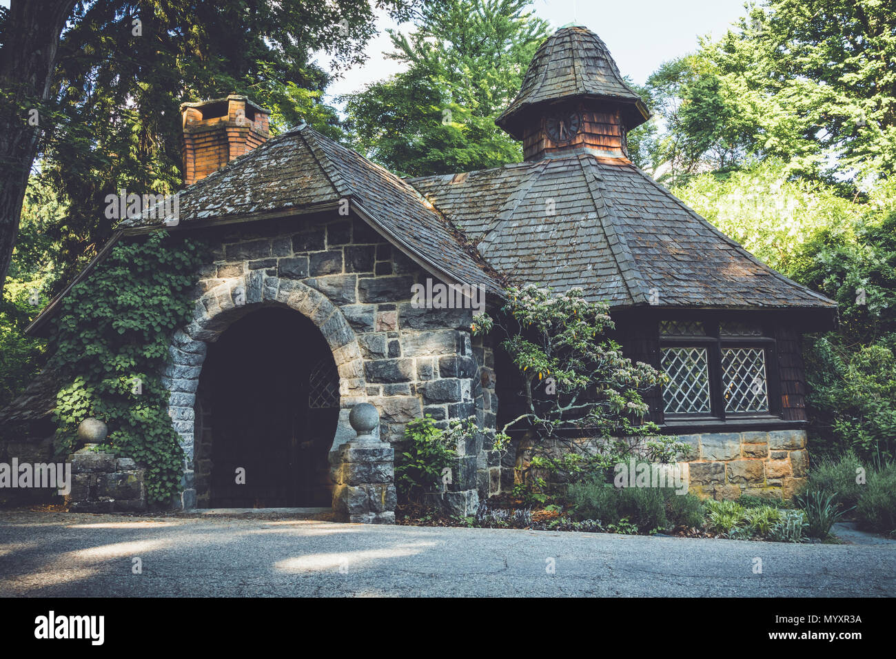 Old stone pumphouse in tudor revival architecture at Ringwood State Park, NJ in vintage setting Stock Photo