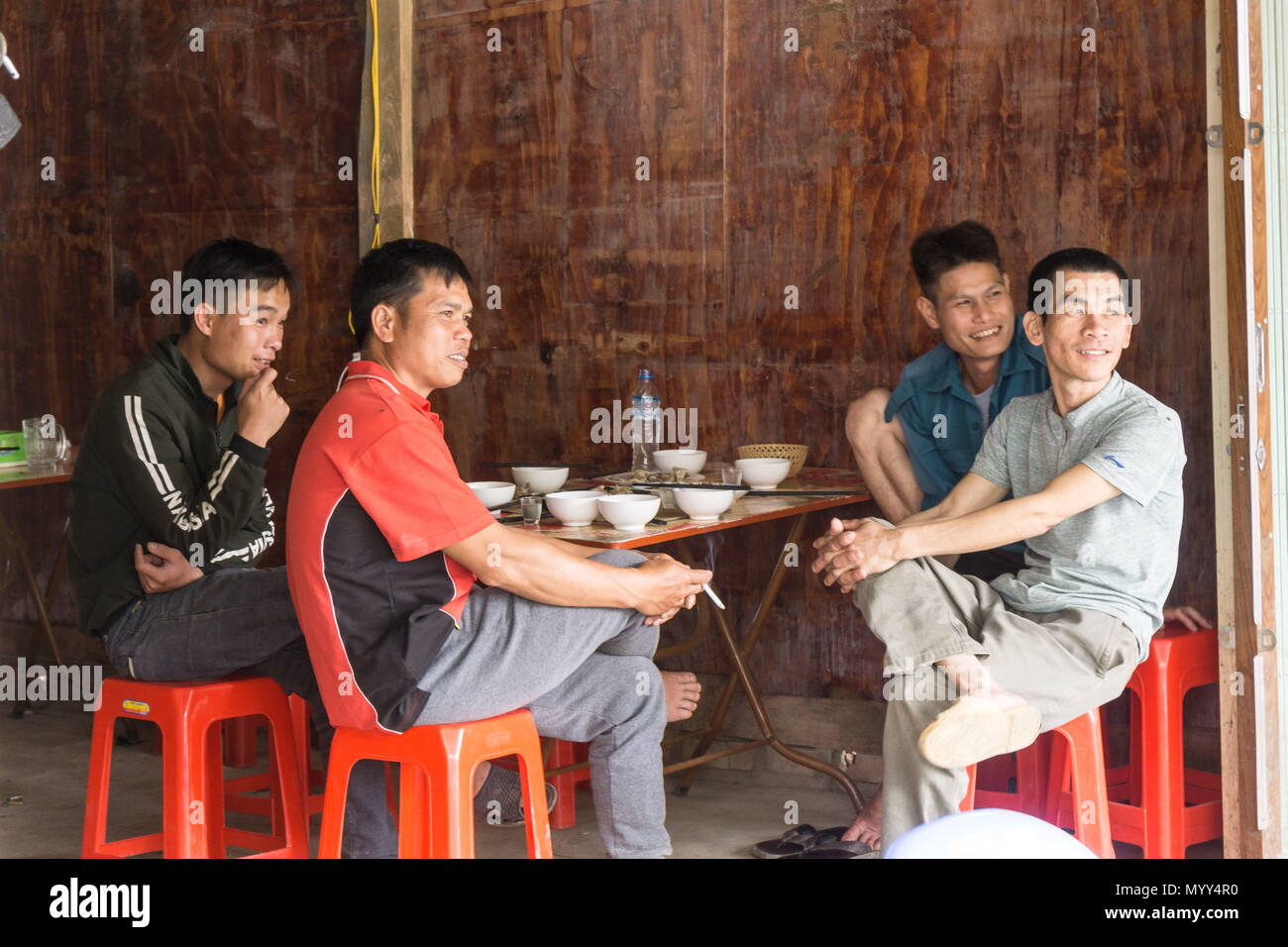 Men in a restaurant, Cao Bang Province, North Vietnam Stock Photo