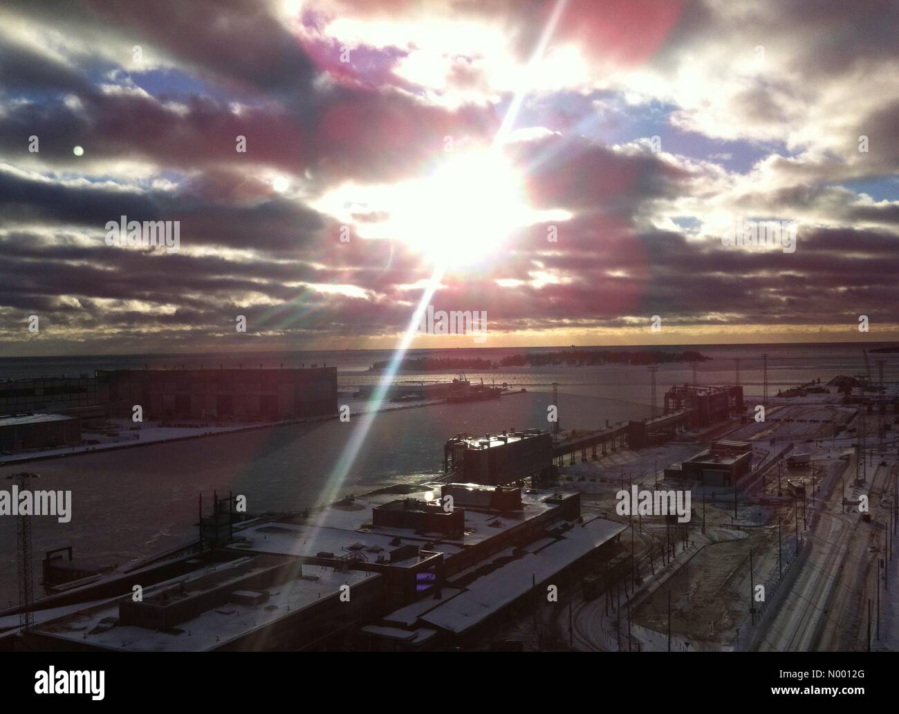 Helsinki, Finland. 13th January, 2015. 13th January, 2015. Rapidly changing weather hits Helsinki, Finland. The sun is seen Tuesday afternoon at West Harbour, Helsinki, after heavy snow fall and rising temperature during the night. Credit:  Heini Kettunen / StockimoNews/Alamy Live News Stock Photo