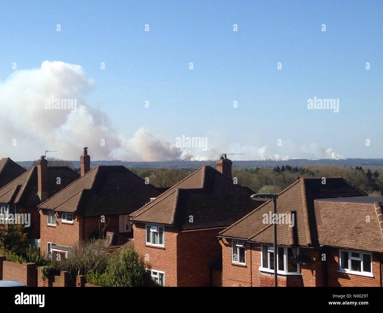 Guildford, UK. 18th Apr, 2015. Smoke billows into the blue sky from the Ash Ranges Heath fire at Guildford in Surrey Credit:  HD1994 / StockimoNews/Alamy Live News Stock Photo