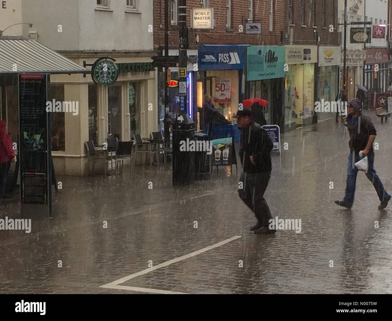 Newbury, Berkshire, UK. 18th May, 2016. UK Weather Shoppers running in