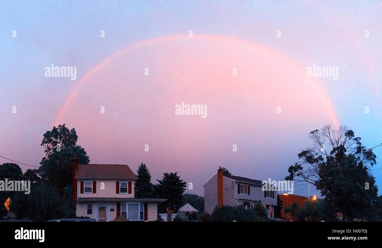 Park Ave, Merrick, New York, USA. 05th June, 2016. Pink rainbow at dusk after rainy spring day
