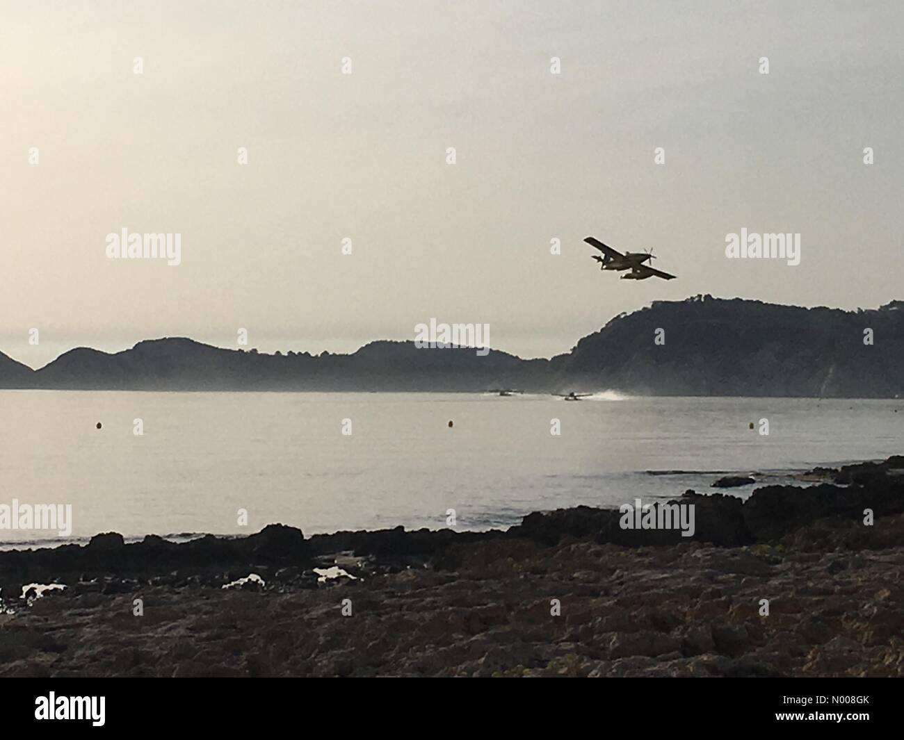 Fire fighting planes collecting sea water to fight the out of control