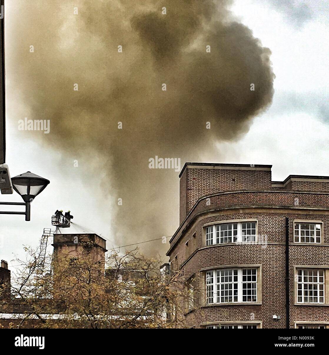 Fire spreads in Exeter. Fire fighters tackle blaze in Cathedral square. Stock Photo