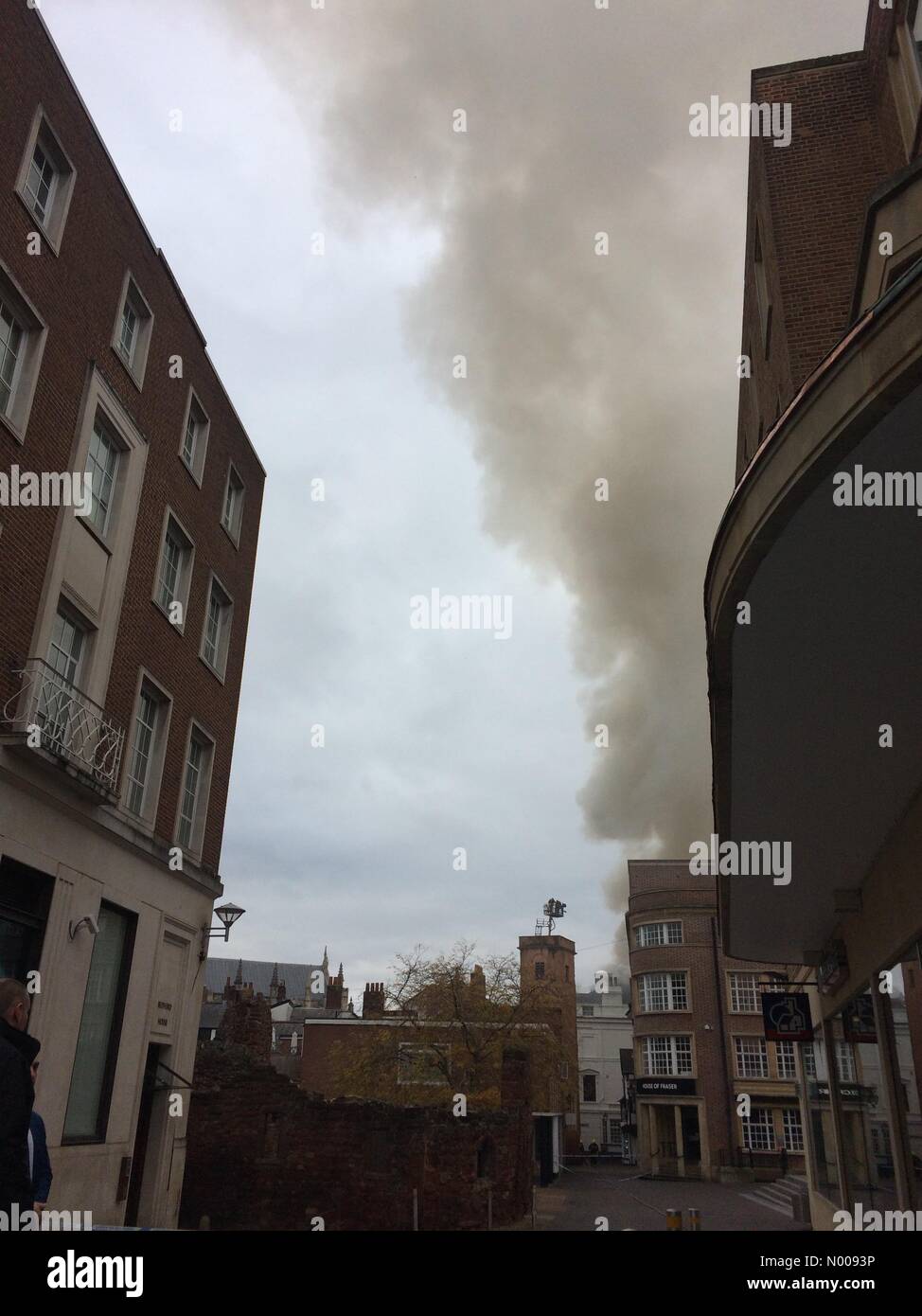 Exeter, UK. 28th Oct, 2016. Exeter, UK. 28th Oct, 2016. A devastating fire has broken out in the centre of Exeter, UK. The fire in Cathedral Square had appeared to be under control but has now spread to the nearby Clarence Hotel. Credit:  timandnic/StockimoNews/Alamy Live News Stock Photo