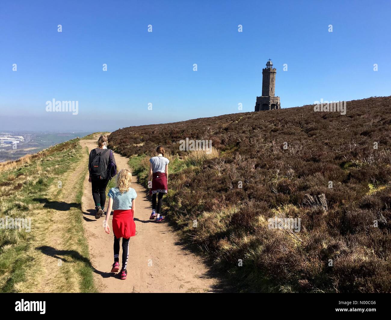 Uk Weather Day In Blackburn Lancashire Family Walking In Sun Towards Darwen Tower On The Moors Above Blackburn Uk Weather Day In Blackburn Lancashire Family Walking In Sun Towards Darwen Tower On The Moors Above Blackburn