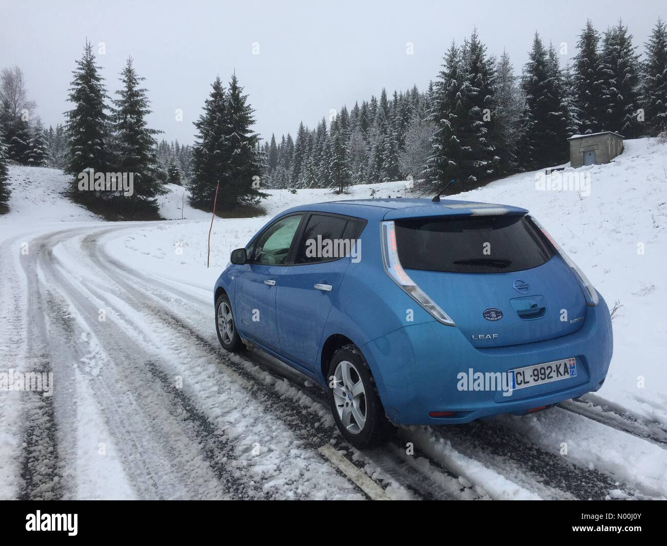 Les Saisies, Savoie, France. 25th November, 2017. Car drives though a winter landscape approaching the ski resort of Les Saisies, Savoie, France after a welcome snowfall before the opening of French ski season. Credit: Graham M. Lawrence/StockimoNews/Alamy Live News Stock Photo