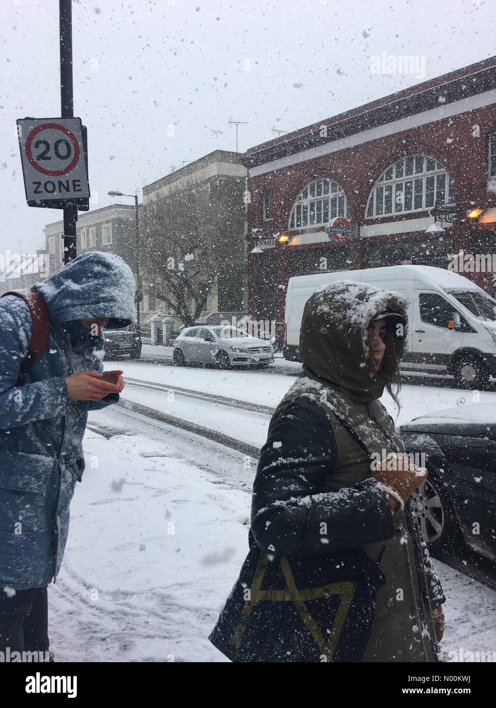 UK Weather.  Struggling through heavy snowfall near Tufnell Park Underground Station, London. 28 February 2018 Stock Photo