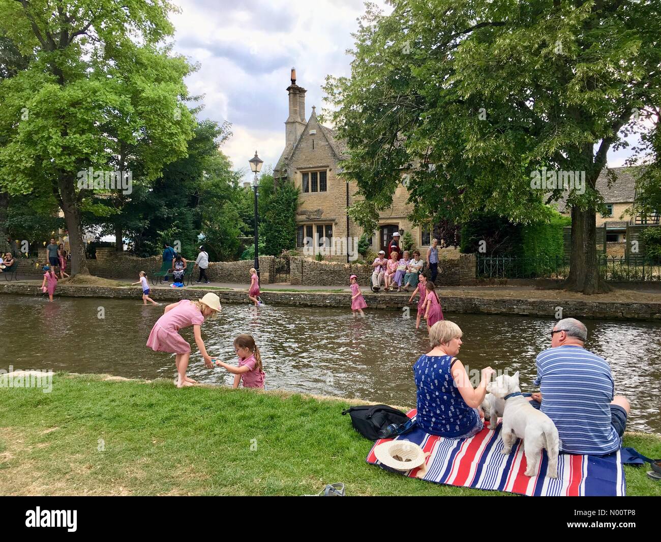 20 July 2018 Bourton-on-the-Water, England, UK Children cool off in the water as temperatures reach 26 C in the Cotswolds. Credit: Lisa Werner/StockimoNews/Alamy Live News Stock Photo