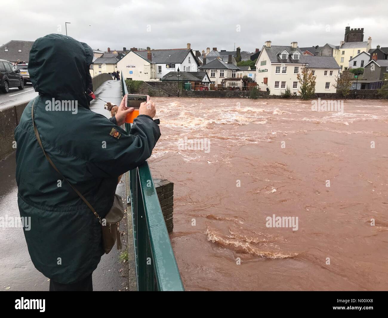 UK Weather - Floodwaters at Brecon Wales - Saturday 13th October 2018 - Visitors stop to watch the high levels on the River Usk in Brecon after Storm Callum brought torrential rain to Wales Stock Photo