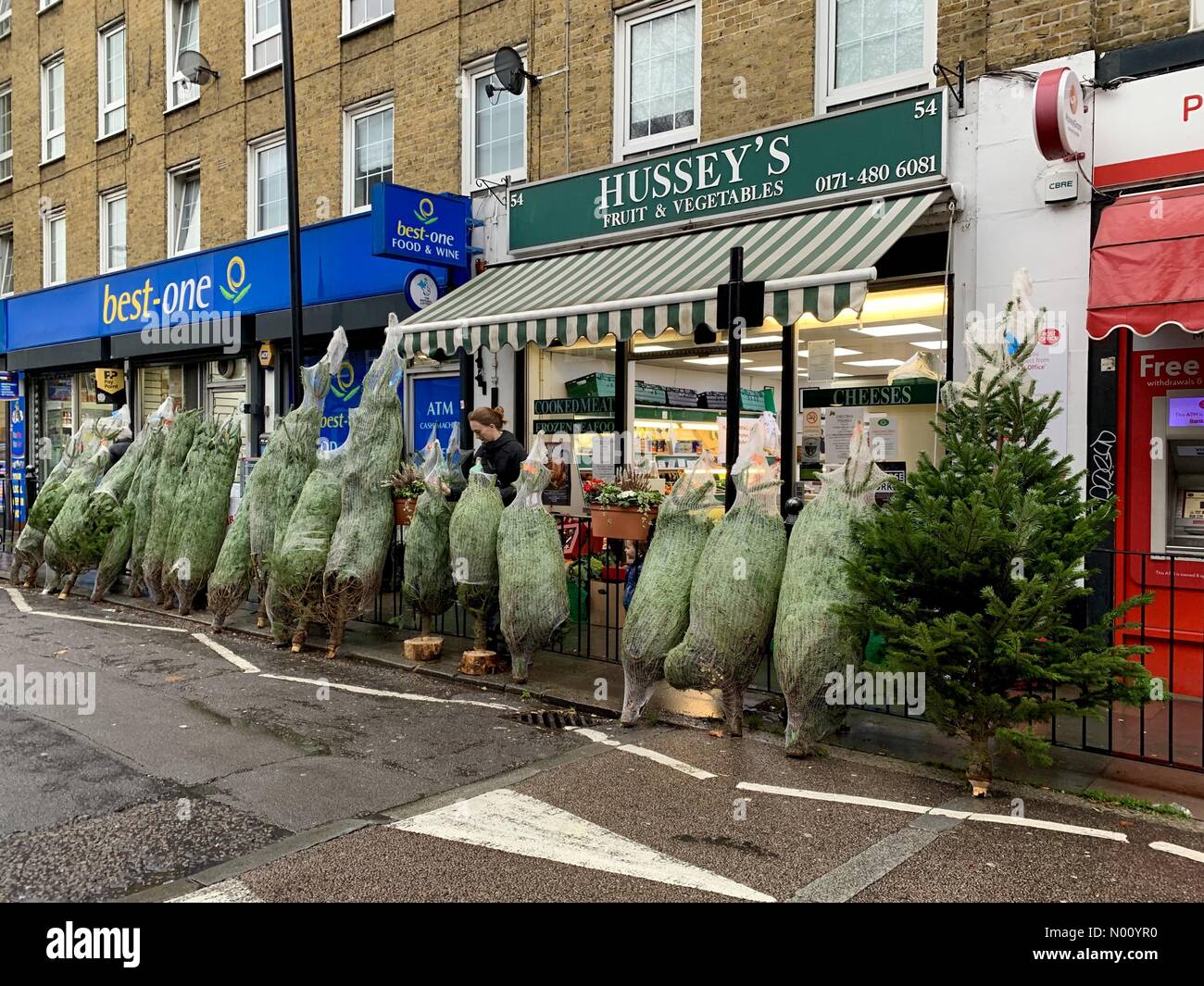 LONDON, UK. 1st December 2018. Christmas trees for sale in the street