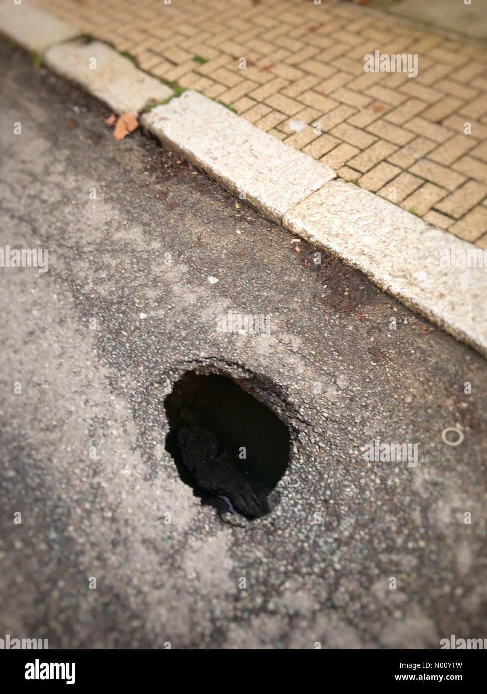 London, UK. 10th December 2018. Sinksized sinkhole on Long Lane, East