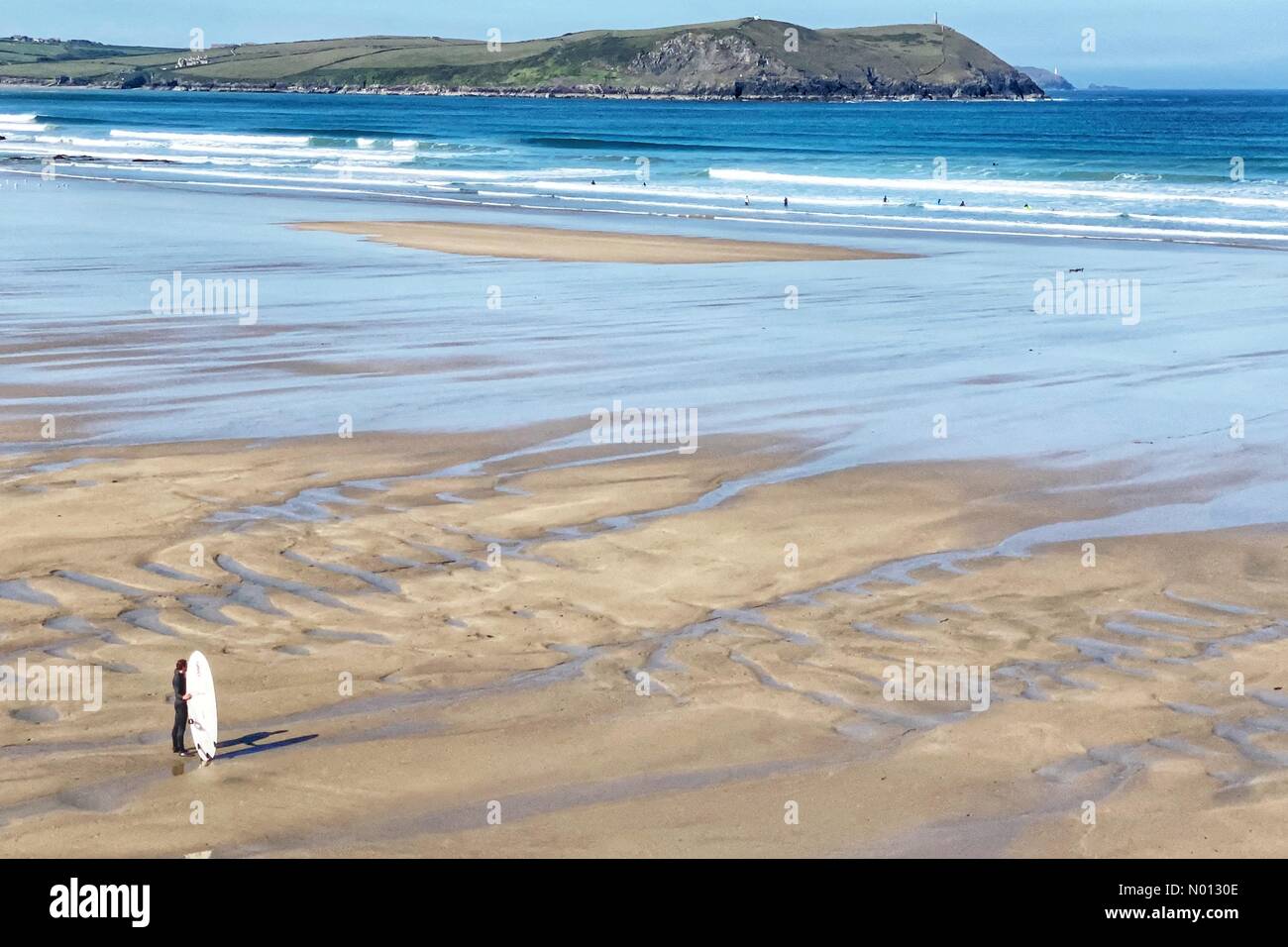 Polzeath beach, Cornwall. 20th May 2020. UK Weather: Lone surfer on an almost deserted Polzeath beach, Cornwall Credit: nidpor/StockimoNews/Alamy Live News Stock Photo