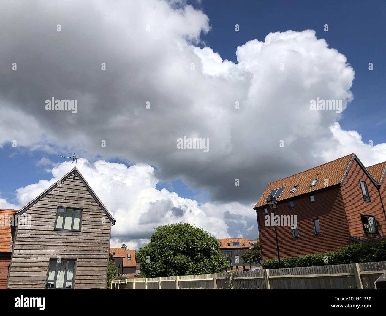 UK Weather: Thunderstorms over Godalming. Sycamore Avenue, Godalming. 16th June 2020. The Met Office issued a yellow warning for thunderstorms for the Home Counties. Building cloud cover in Godalming. Credit: jamesjagger/StockimoNews/Alamy Live News Stock Photo