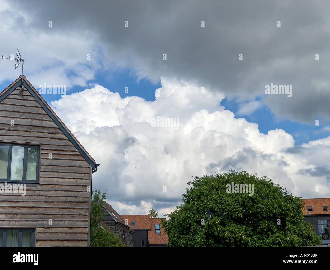 UK Weather: Thunderstorms over Godalming. Sycamore Avenue, Godalming. 16th June 2020. The Met Office issued a yellow warning for thunderstorms for the Home Counties. Building cloud cover in Godalming. Credit: jamesjagger/StockimoNews/Alamy Live News Stock Photo