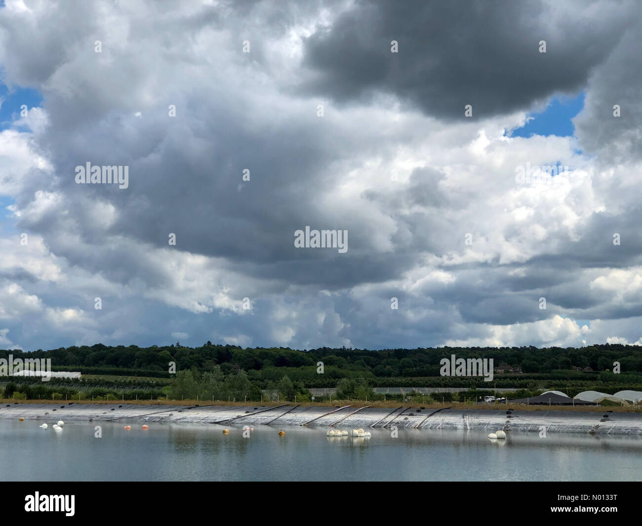 UK Weather: Thunderstorms over Godalming. Tuesley Farm, Godalming. 16th June 2020. The Met Office issued a yellow warning for thunderstorms for the Home Counties. Building cloud cover in Godalming. Credit: jamesjagger/StockimoNews/Alamy Live News Stock Photo