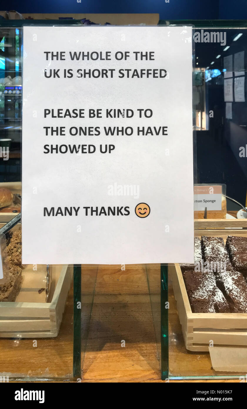UK staff shortage: Sign in the Bishop's Palace café in Wells Somerset calls for patience from customers as staff shortages lead to delays. (C) Paul Swinney/Alamy Live News Credit: Paul Swinney/StockimoNews/Alamy Live News Stock Photo