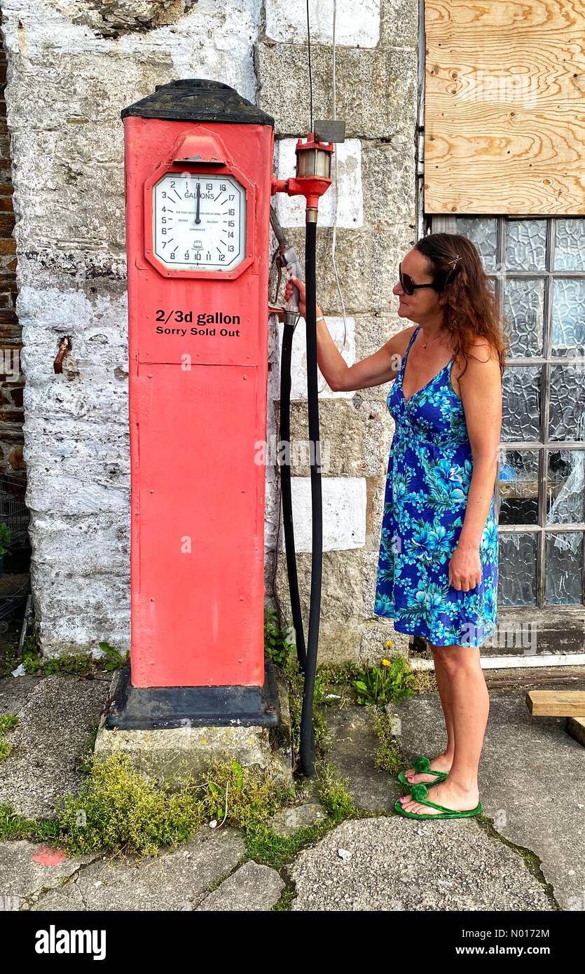 Cornwall, UK. 21st May, 2022. Raich Keene inspects vintage fuel pumps as cost of fuel across UK continues to rise, St Mawes, Cornwall, UK. 21st May, 2022. Credit: nidpor / StockimoNews/Alamy Live News Stock Photo