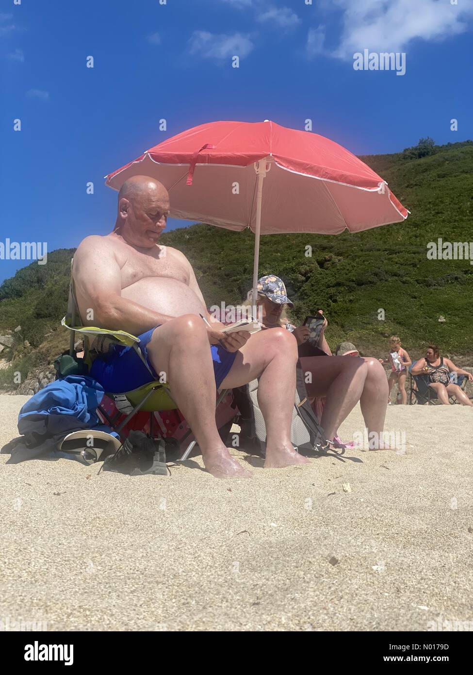 Cornwall, UK. 15th July, 2022. UK Weather: Sunbathing at Porthcurno, Cornwall, UK. 15 July 2022. Credit: nidpor / StockimoNews/17�Թ����� Live News Stock Photo