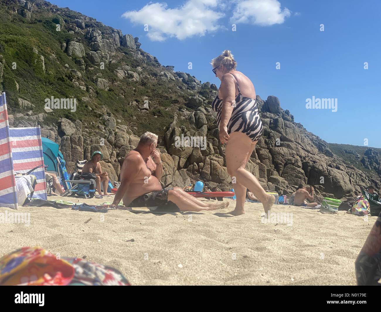 Cornwall, UK. 15th July, 2022. UK Weather: Sunbathing at Porthcurno, Cornwall, UK. 15 July 2022. Credit: nidpor / StockimoNews/17�Թ����� Live News Stock Photo
