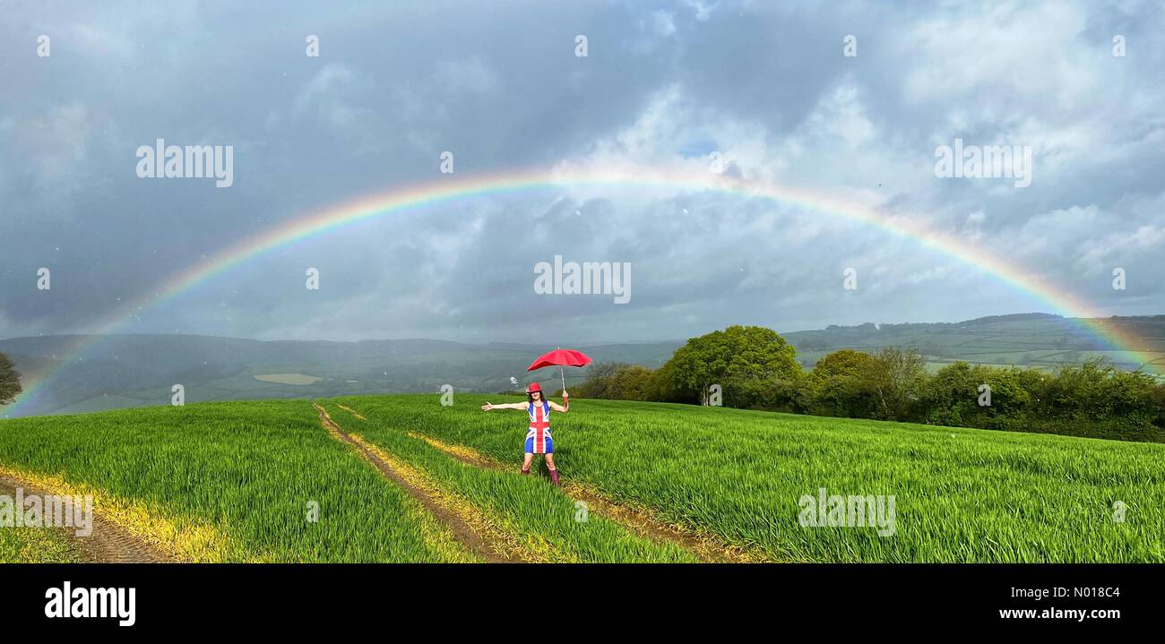 UK Weather: Raich Keene under a Colourful Rainbow in changeable conditions for Coronation weekend at Dunsford in Devon, UK. 5 May, 2023. Credit nidpor/ Alamy Live News Credit: nidpor/StockimoNews/Alamy Live News Stock Photo
