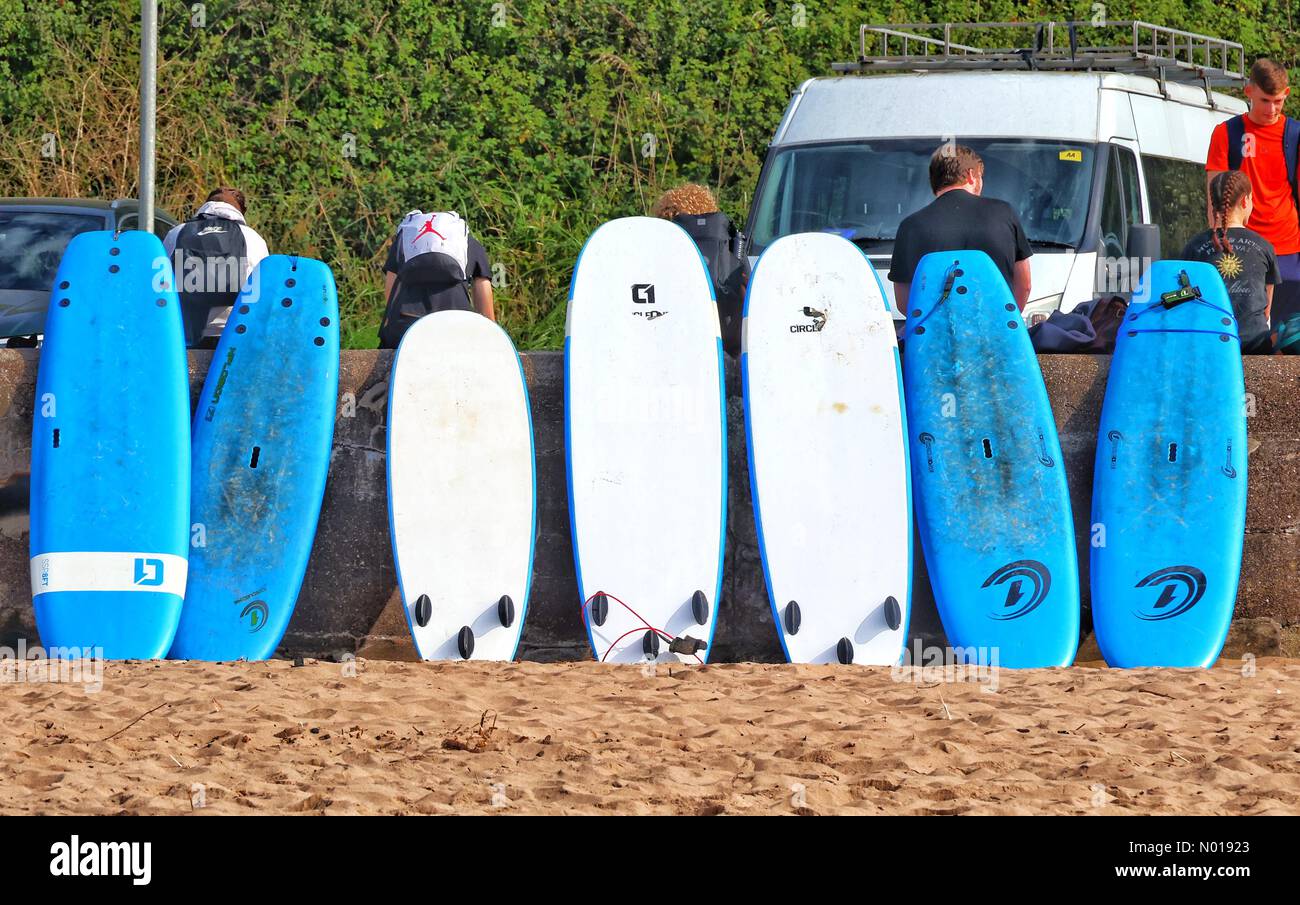 UK Weather line of paddle boards on a fine sunny day at Exmouth beach