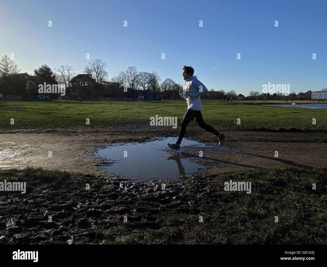 UK Weather Wimbledon, London, UK. 7 January 2024. A jogger running in