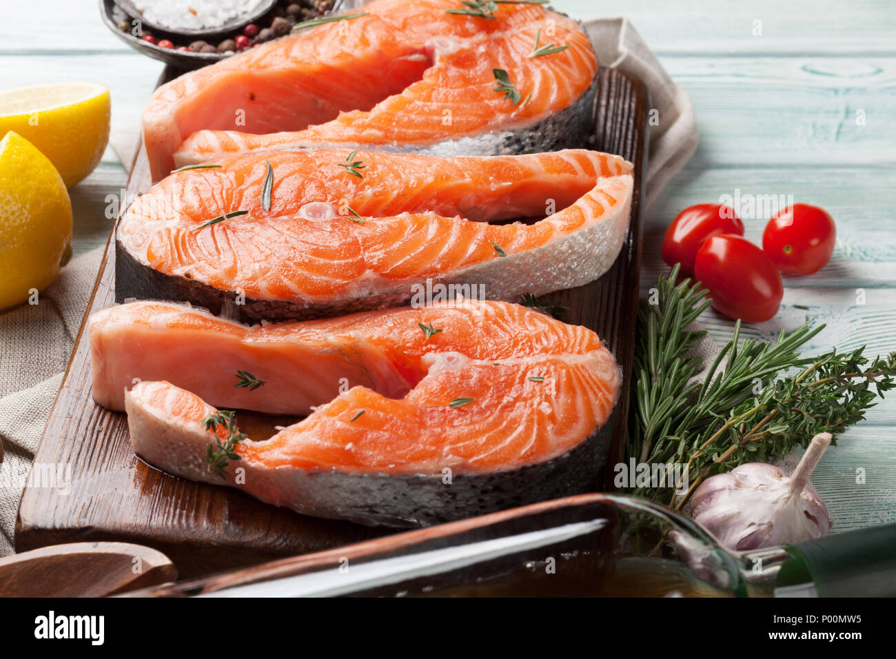 Raw salmon fish steaks with spices cooking on cutting board Stock Photo ...
