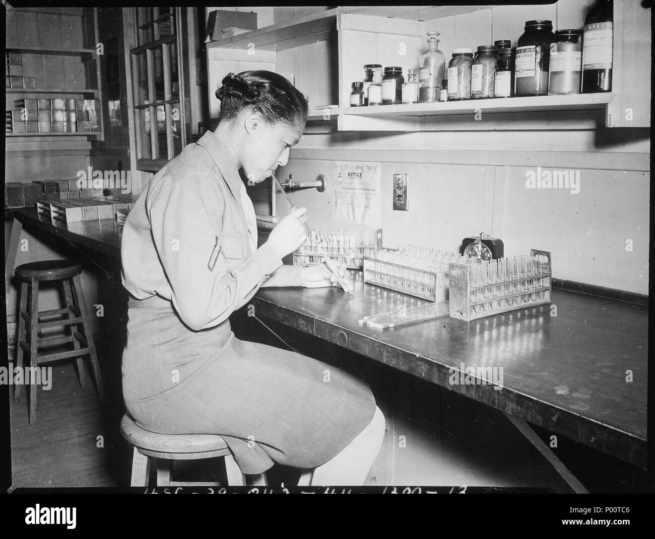 Pfc. Johnnie Mae Welton, Negro WAC, laboratory technician trainee, conducts an experiment in the