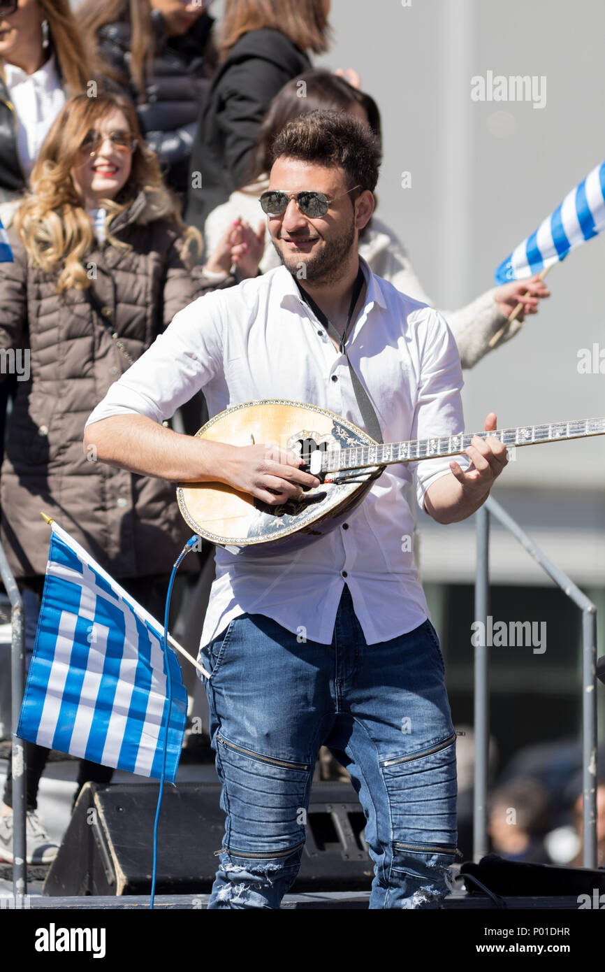 Chicago, Illinois, USA - April 29, 2018 Greek man playing Baglamas during the  Greek Independence  Day Parade Stock Photo