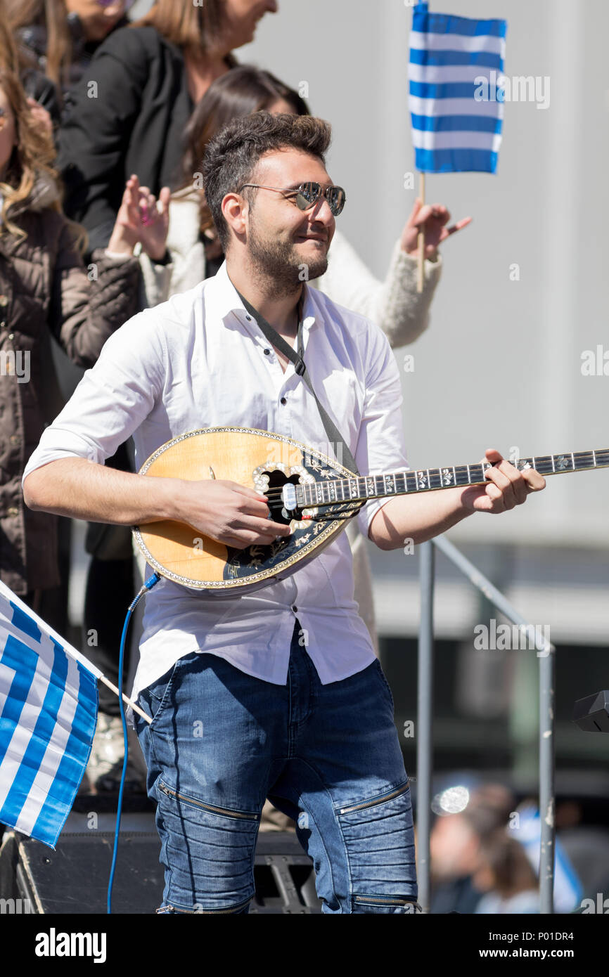 Chicago, Illinois, USA - April 29, 2018 Greek man playing Baglamas during the  Greek Independence  Day Parade Stock Photo