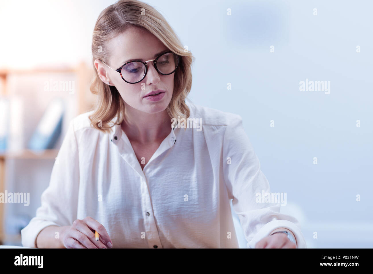 Attractive pleasant woman being involved in work Stock Photo