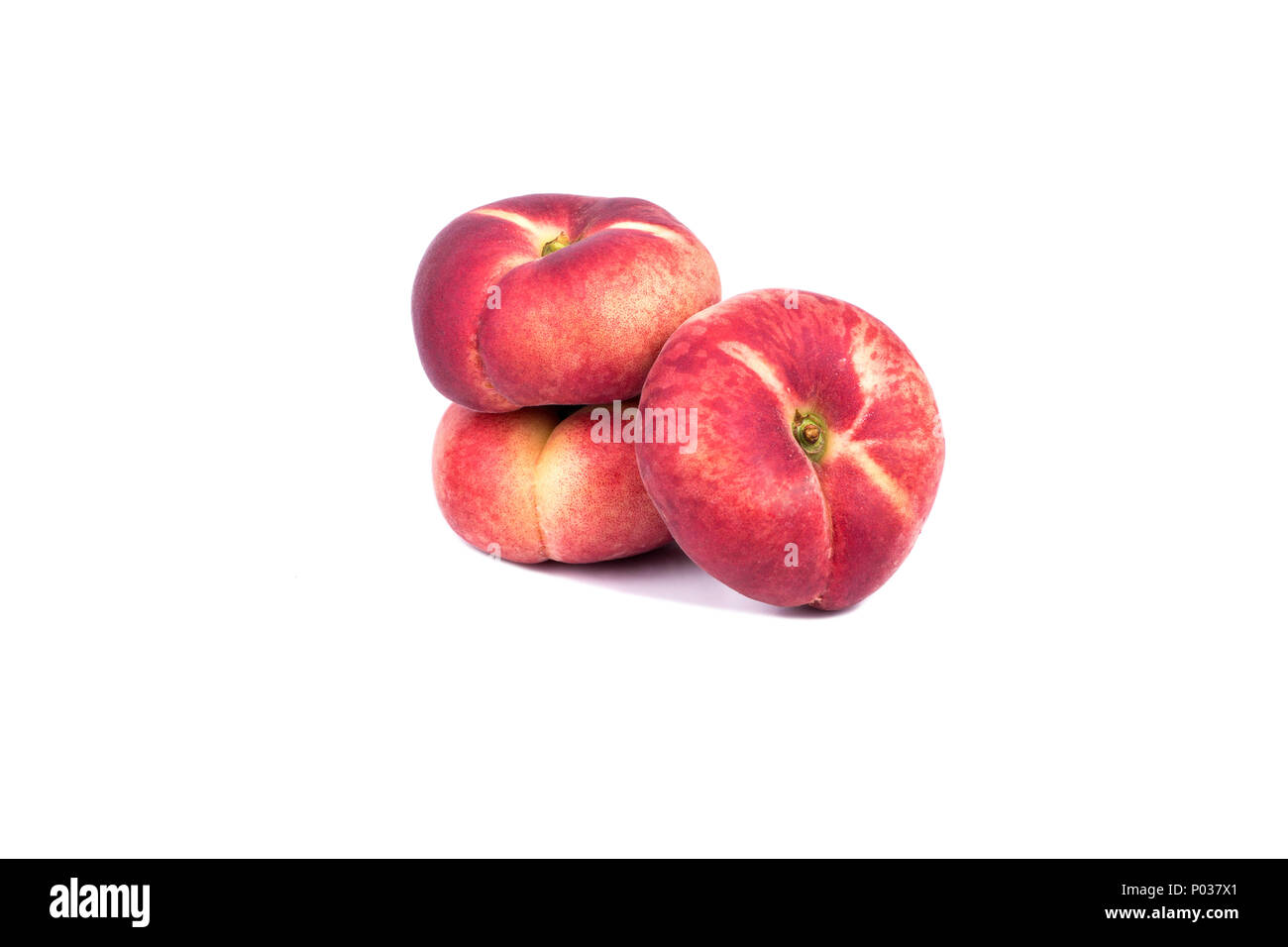 Three fresh red flat peaches on a white background Stock Photo