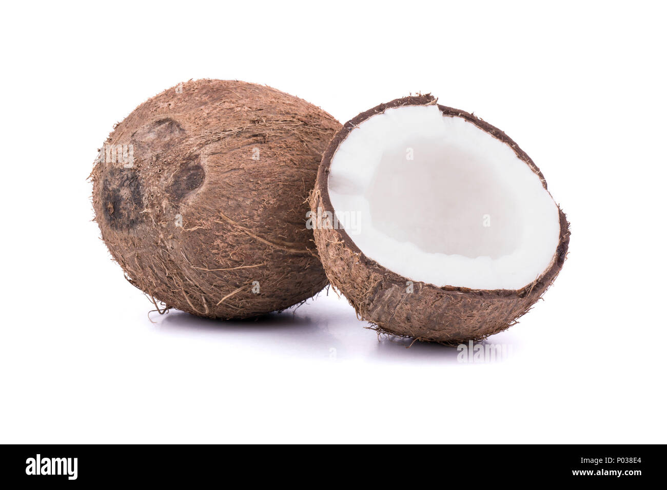 Full ripe coconut with a broken half on a white background Stock Photo ...