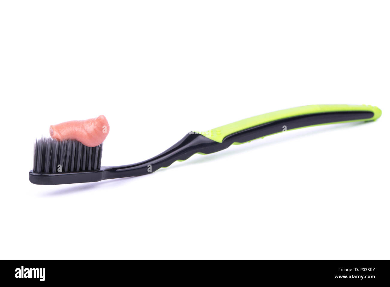 Toothbrush black and green with toothpaste on a white background Stock Photo