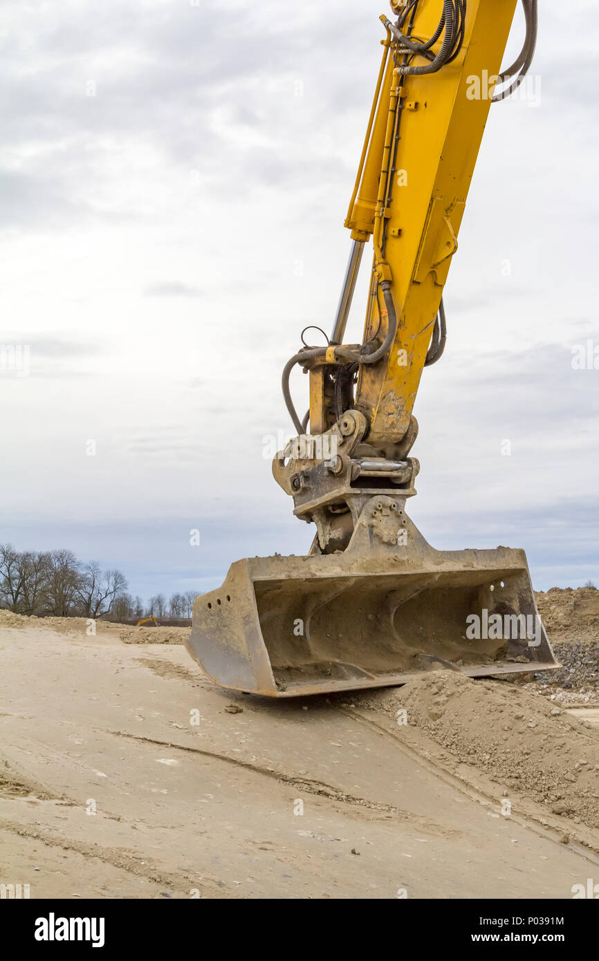 Yellow Power Shovel In The Dirt Spotted In A Quarry Stock Photo