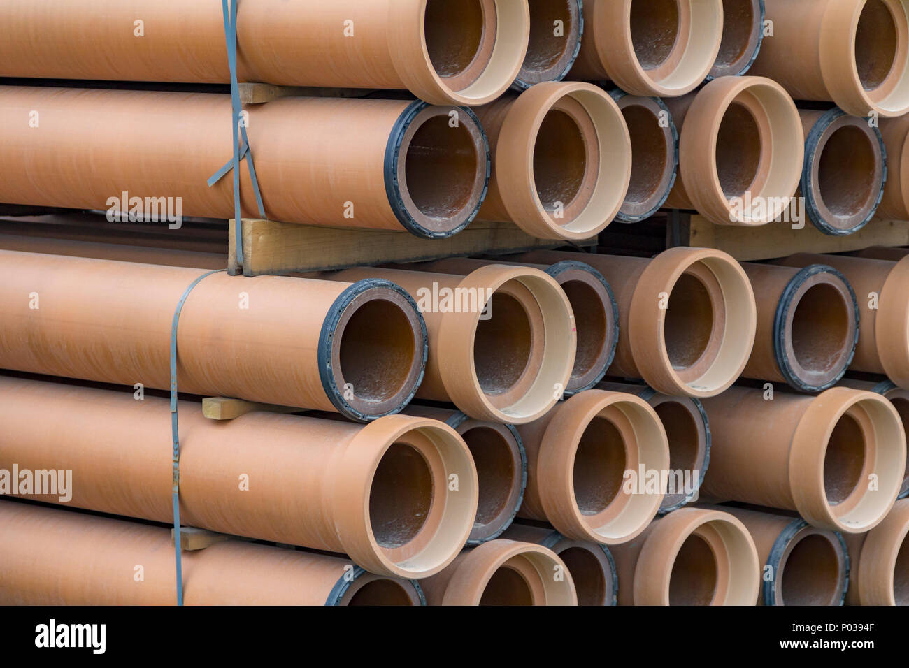 full frame closeup shot of some stacked earthenware pipes Stock Photo